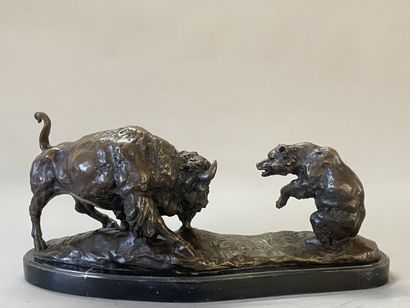 Bison facing a bear. 
Modern sculpture in...