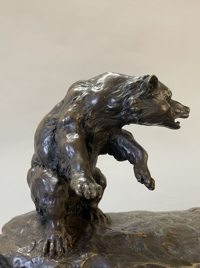 Bison facing a bear. 
Modern sculpture in...