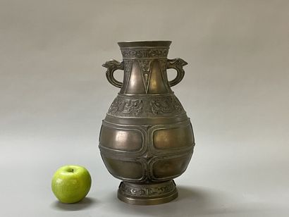 Bronze vase with stylized decoration. Mark...