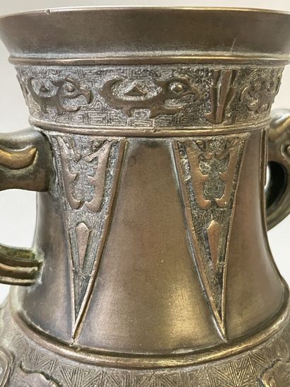 Bronze vase with stylized decoration. Mark...