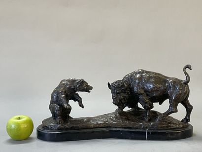 Bison facing a bear. 
Modern sculpture in...