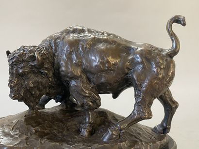Bison facing a bear. 
Modern sculpture in...
