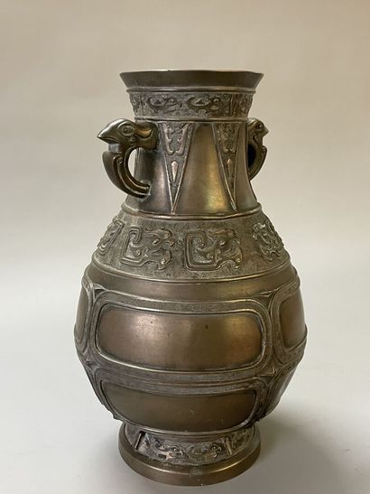 Bronze vase with stylized decoration. Mark...