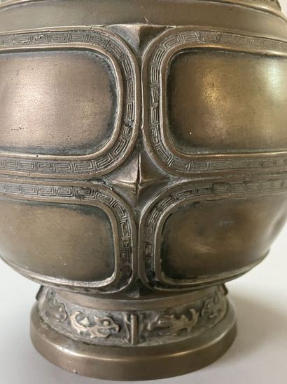 Bronze vase with stylized decoration. Mark...