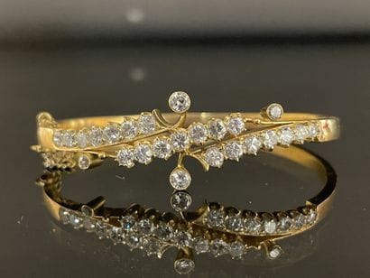 Gold bracelet set with lines of scrolling...