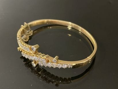 Gold bracelet set with lines of scrolling...