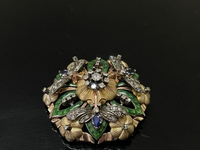 A circular pendant brooch depicting a flower...