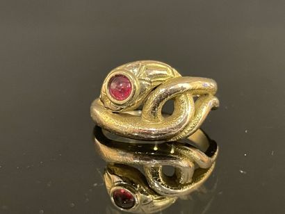 Gold snake ring with a small ruby in a closed...