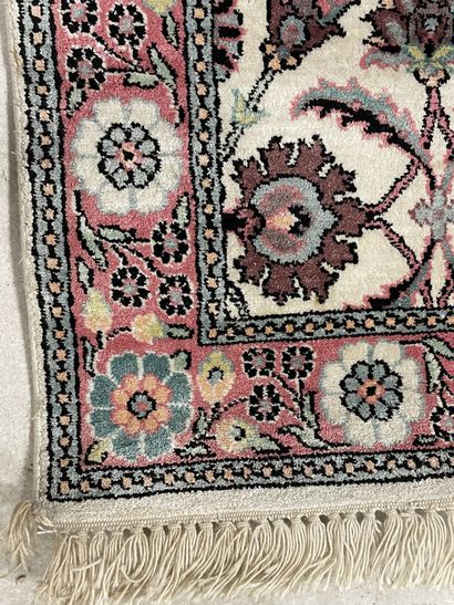 Silk carpet decorated with pink flowers on...