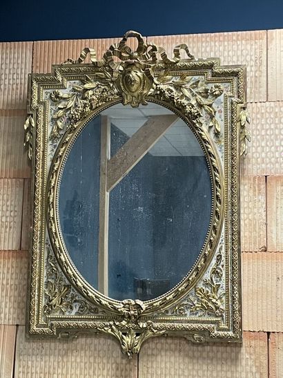Wood and stucco mirror gilded and lacquered...