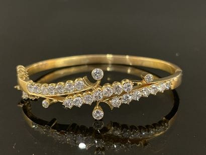 Gold bracelet set with lines of scrolling...