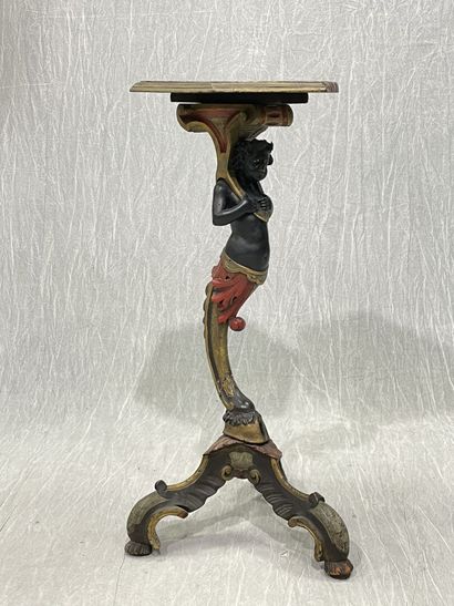 Carved wood pedestal table with patina, featuring...