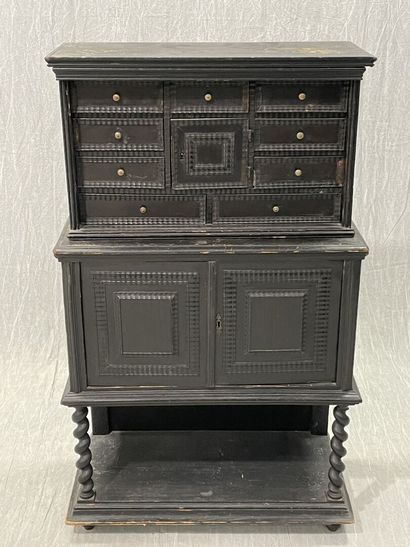 Cabinet in blackened wood opening to 9 drawers...