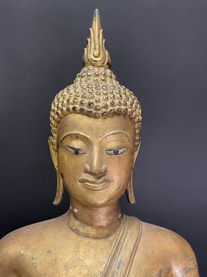 Buddha seated in virasana on a plinth adorned...