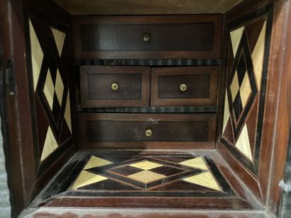 Cabinet in blackened wood opening to 9 drawers...