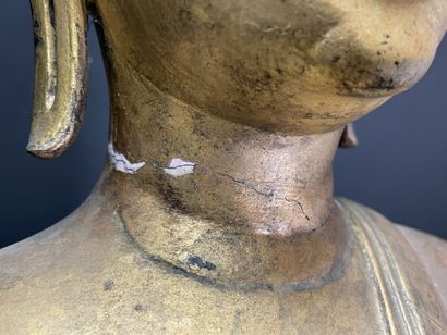 Buddha seated in virasana on a plinth adorned...