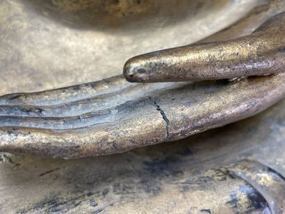 Buddha seated in virasana on a plinth adorned...