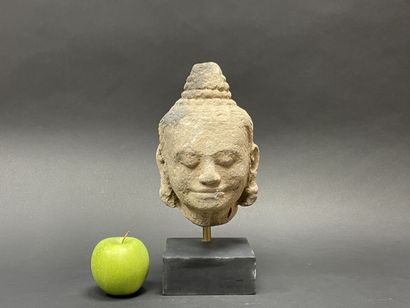 An ancient head of a mucalinda Buddha, smiling...