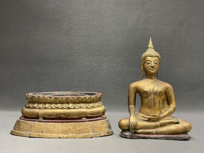 Buddha seated in virasana on a plinth adorned...
