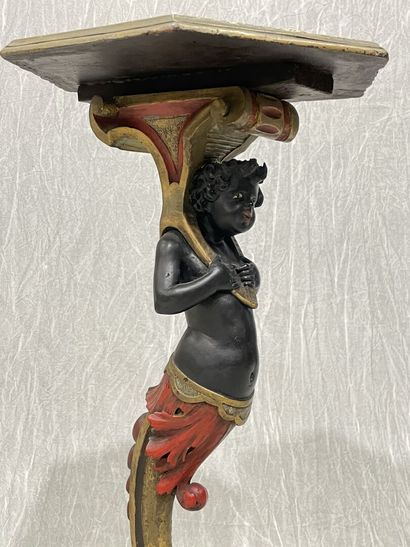 Carved wood pedestal table with patina, featuring...