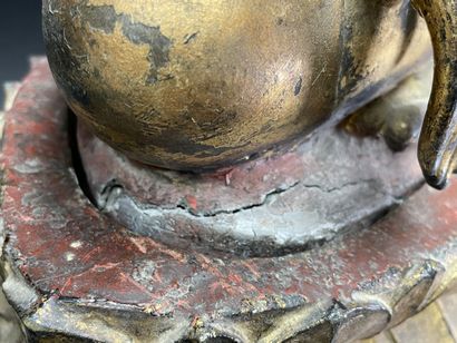 Buddha seated in virasana on a plinth adorned...