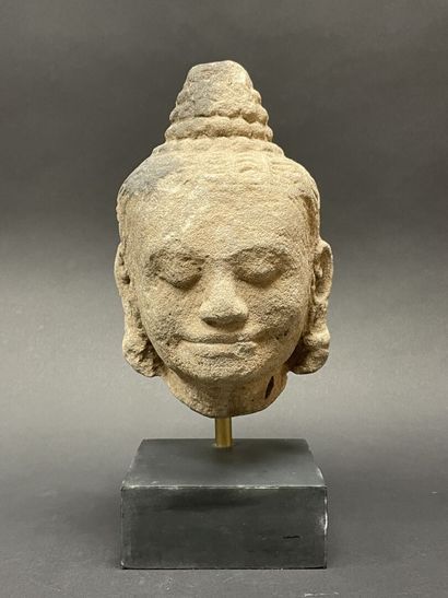 An ancient head of a mucalinda Buddha, smiling...
