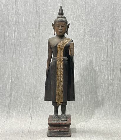 Ancient standing Buddha resting on a plinth,...
