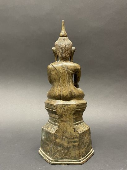 Ancient Buddha seated in majesty on a lotus-decorated...