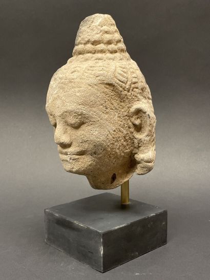 An ancient head of a mucalinda Buddha, smiling...