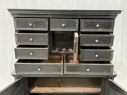 Cabinet in blackened wood opening to 9 drawers...