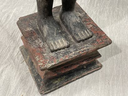Ancient standing Buddha resting on a plinth,...