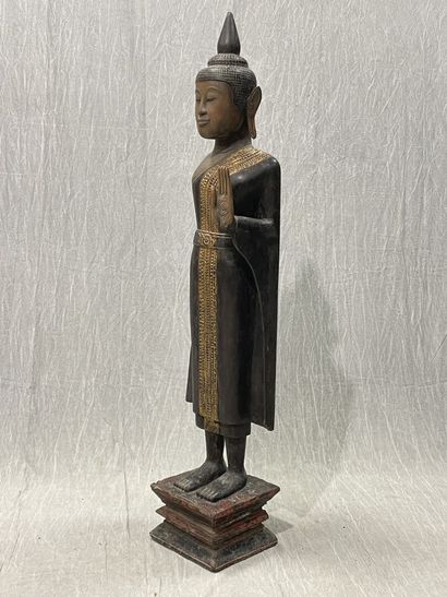 Ancient standing Buddha resting on a plinth,...