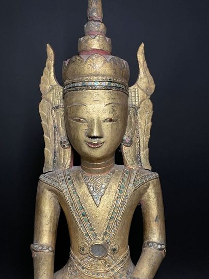 Buddha adorned in the royal effigy, wearing...