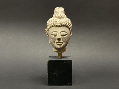 Old smiling Buddha head. Stoneware sculpture.
Siam...