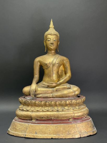 Buddha seated in virasana on a plinth adorned...