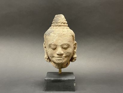 An ancient head of a mucalinda Buddha, smiling...