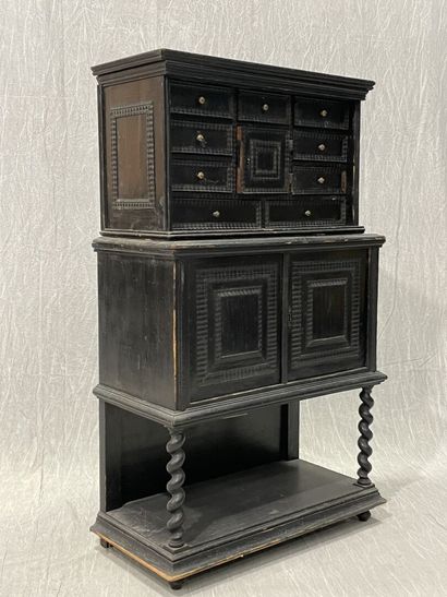 Cabinet in blackened wood opening to 9 drawers...