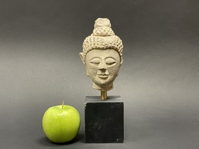 Old smiling Buddha head. Stoneware sculpture.
Siam...