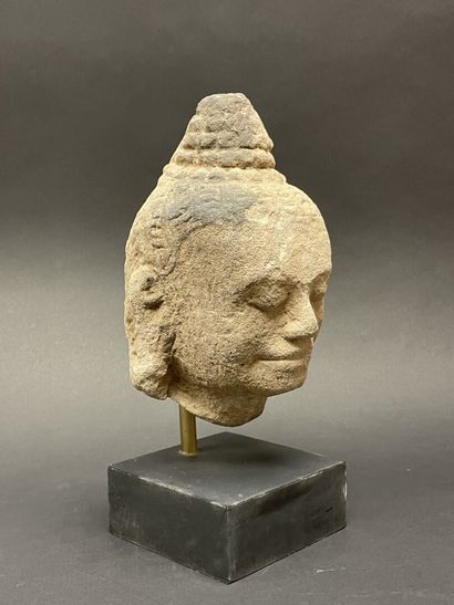 An ancient head of a mucalinda Buddha, smiling...