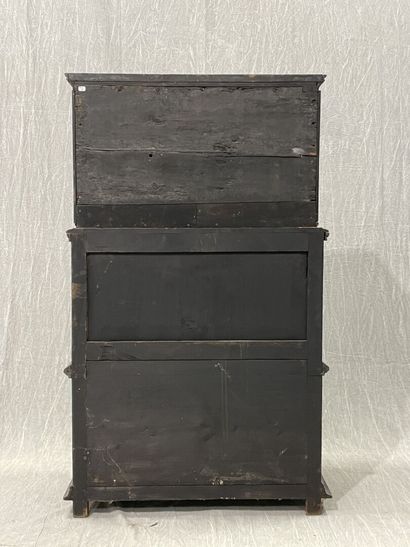 Cabinet in blackened wood opening to 9 drawers...
