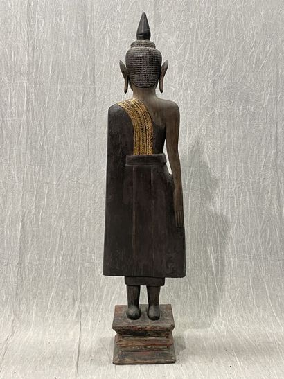 Ancient standing Buddha resting on a plinth,...