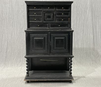 Cabinet in blackened wood opening to 9 drawers...