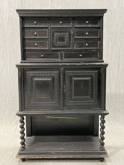 Cabinet in blackened wood opening to 9 drawers...