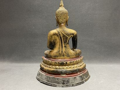 Buddha seated in virasana on a plinth adorned...