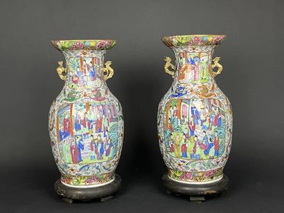 Pair of polychrome porcelain vases, richly...