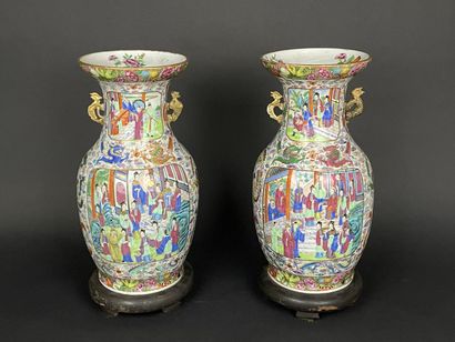 Pair of polychrome porcelain vases, richly...