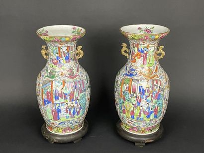 Pair of polychrome porcelain vases, richly...