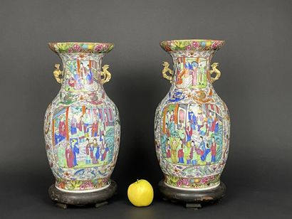 Pair of polychrome porcelain vases, richly...