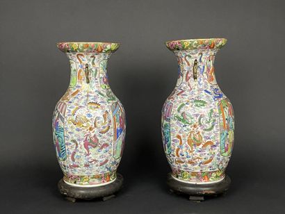 Pair of polychrome porcelain vases, richly...
