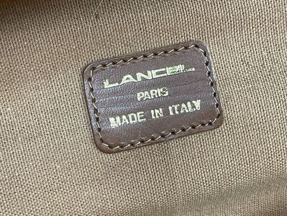 LANCEL Valise souple en toile et cuir
On...